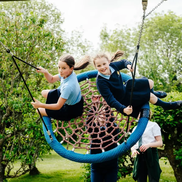 Prep school girls on swing